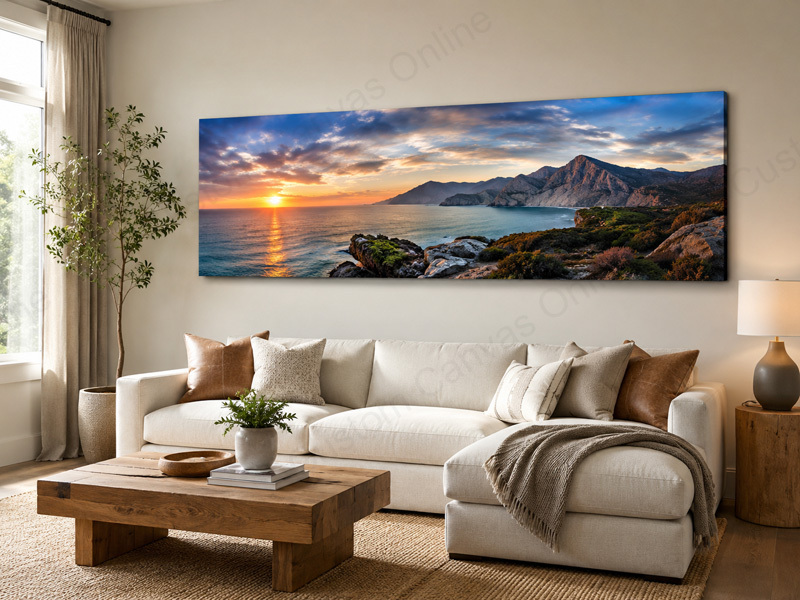 A modern living room featuring a large panoramic photo canvas print above the sofa, showcasing a wide coastal sunset landscape. This image demonstrates how panoramic photo canvas prints can turn wide landscape photos into stunning wall art for home decor.